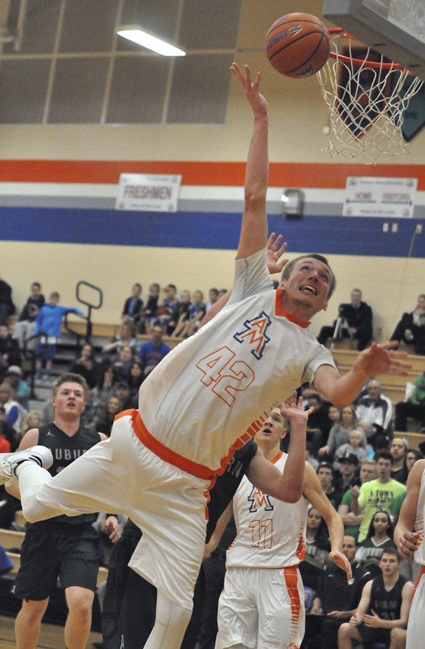 Tristan Miguel scores two of his 13 points in Auburn Mountainview’s 60-50 South Puget Sound League 3A boys basketball victory over Auburn.