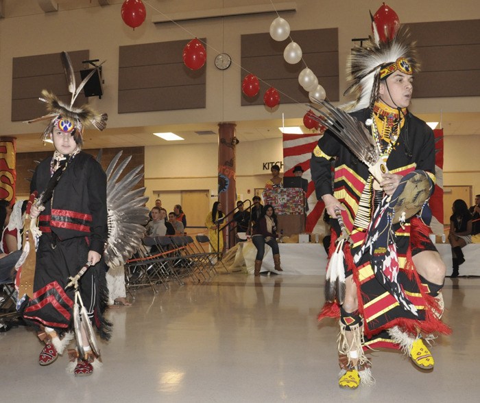 Mark Sison and his son Tyler perform a Native American dance at Auburn Mountainview High School's Fall Multicultural Fair.