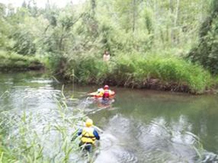 Mountain View Fire and Rescue crews wade over to the island where a man spent the night after he and his dog fell out of their raft.