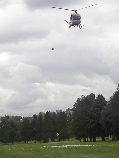 An empty bucket is released from a helicopter after its contents