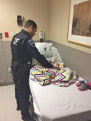 Auburn Police officer Andrew Lindgren checks on the progress of a 14-month-old girl he rescued from a homeless camp. COURTESY PHOTO