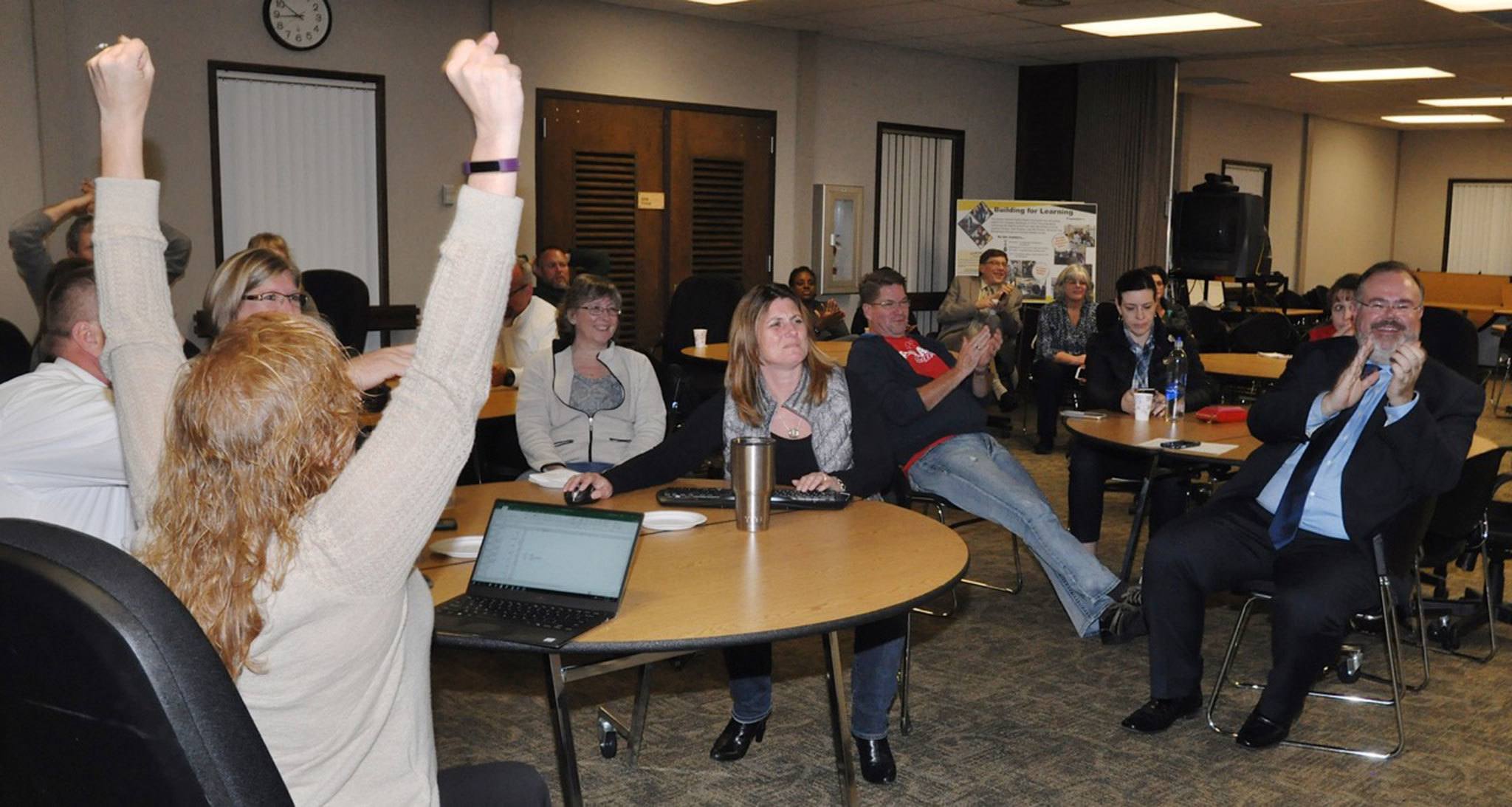 Auburn School District superintendent Alan Spicciati and other supporters celebrate early returns Tuesday night for King and Pierce counties. Between the counties, the capital facilities bond was passing with 60.2 percent of 19,518 ballots cast to rebuild six schools and construct two new ones. RACHEL CIAMPI, Auburn Reporter