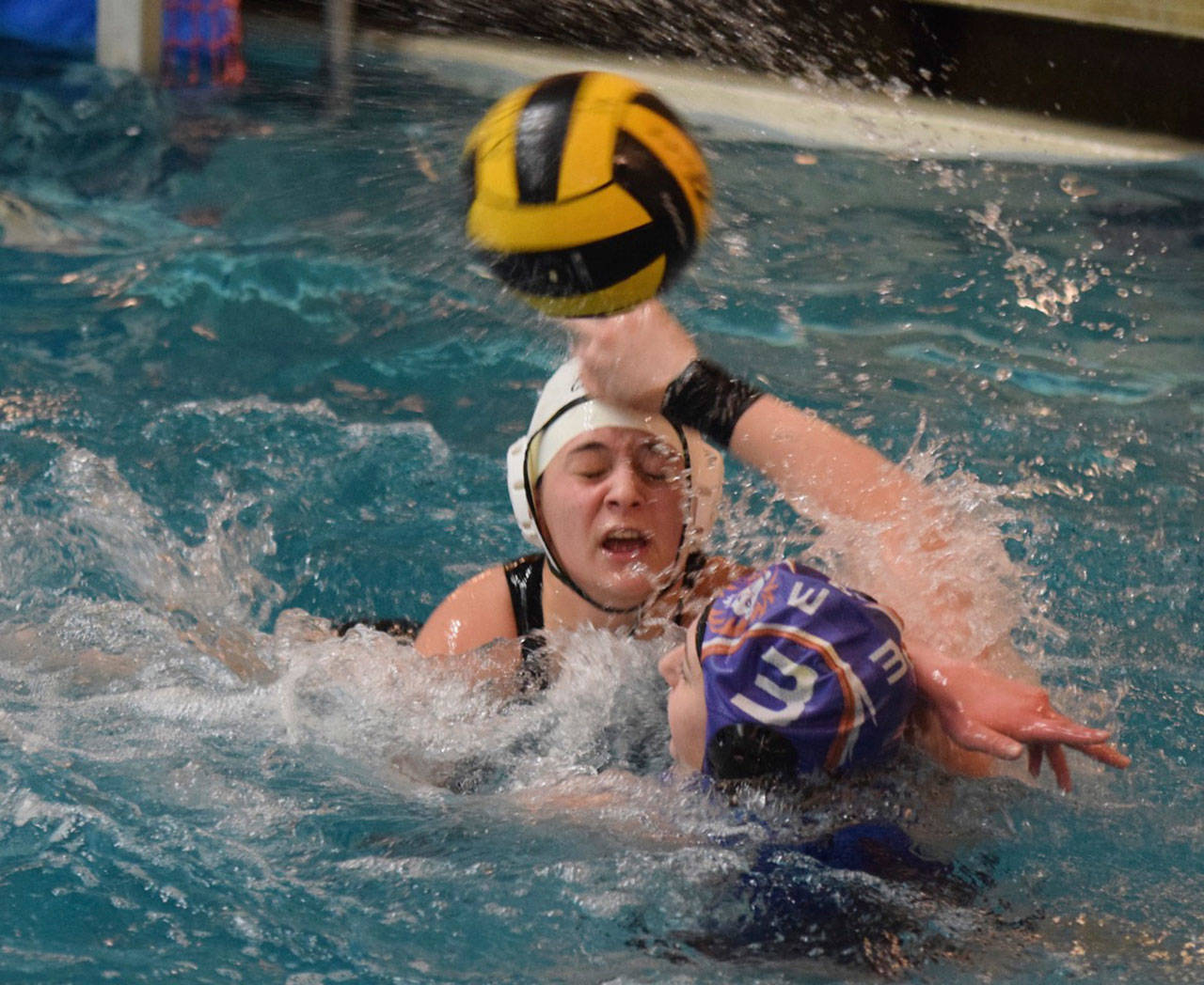 Auburn Mountainview’s Janeese Singer (3) throws the ball past Kentridge’s Sam Gilman during water polo action Thursday. RACHEL CIAMPI, Auburn Reporter