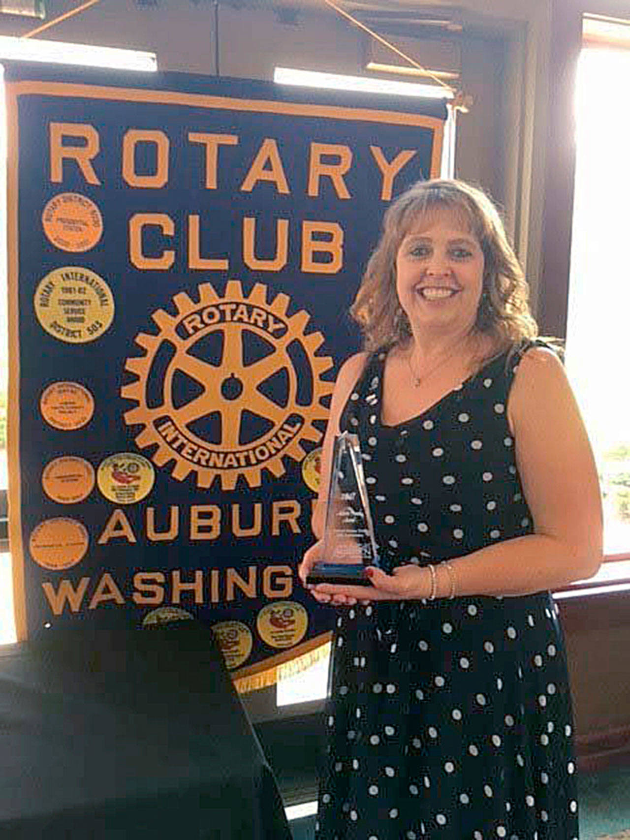 Auburn Rotary Club president Cindi Blansfield stands with the Auburn Proud award following the organization’s 60th anniversary celebration. COURTESY PHOTO