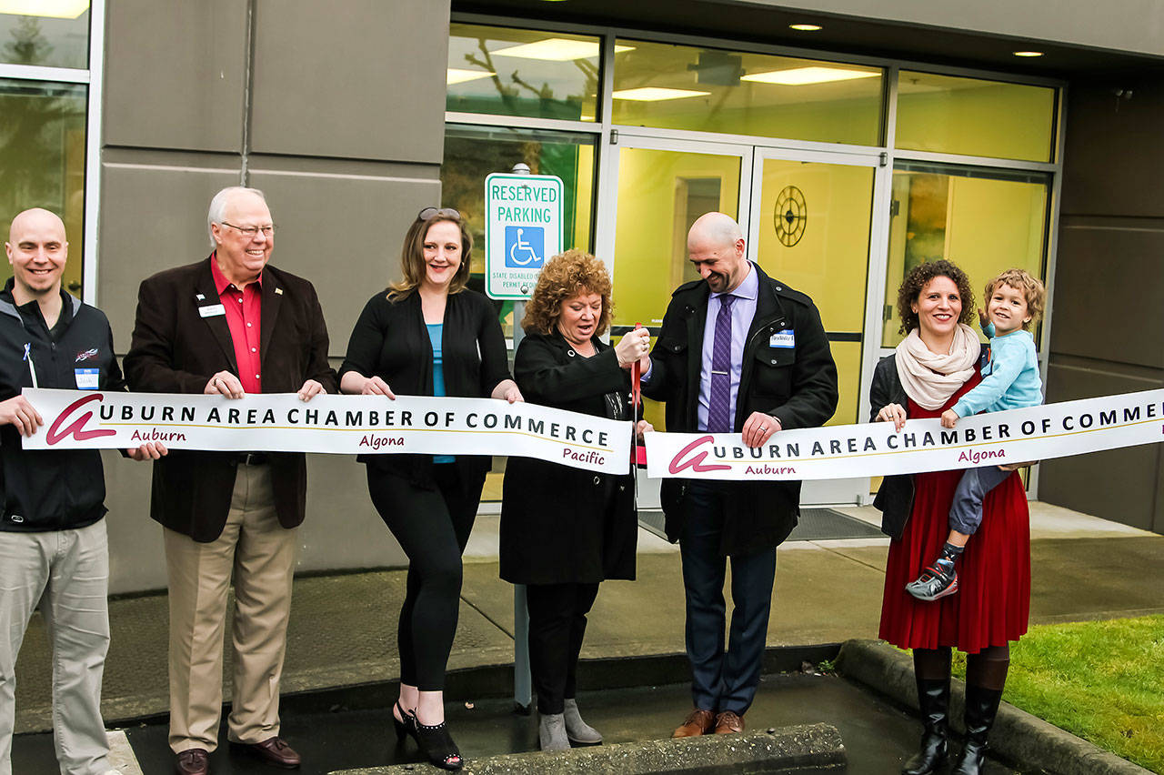 Emerald Installation CEO Alexander Rodenko and Mayor Nancy Backus cut the ribbon at the company’s new Auburn warehouse. COURTESY PHOTO, Behling Photography