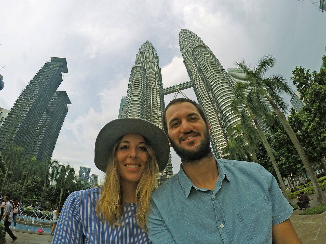 Madison and Jake Leland smile in front of the Petronas Towers in Kuala Lumpur, Malaysia, in May, one of the many countries they have explored in their extensive travels. COURTESY PHOTO