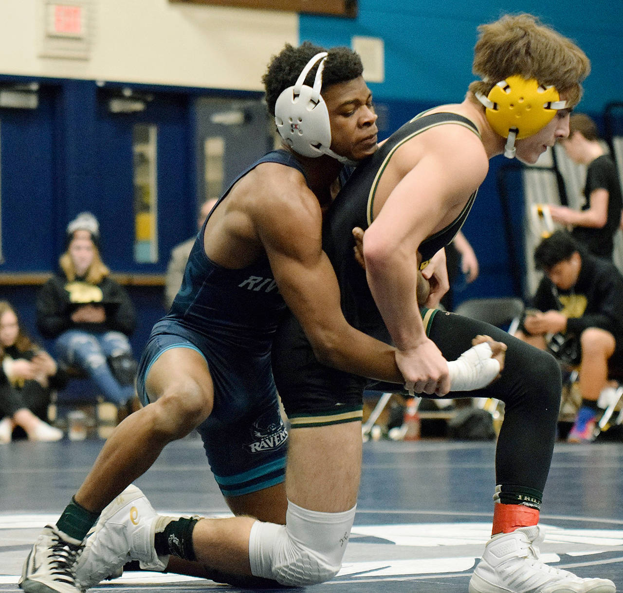 Auburn Riverside’s Yusef Nelson, left, ties up Auburn’s Alex Contreras during their 126-pound match Wednesday. Nelson won by fall at the 5:13 mark. RACHEL CIAMPI, Auburn Reporter