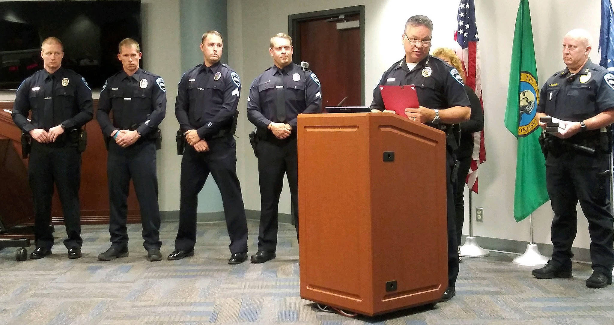 Auburn Police force honorees are, from left, Officers Devin Nelson, David Lind, Sgt. Brandon Skeen and Officer Brian Anderson. Police Chief William Pierson is at the podium, alongside Assistant Chief Mark Callier. ROBERT WHALE, Auburn Reporter