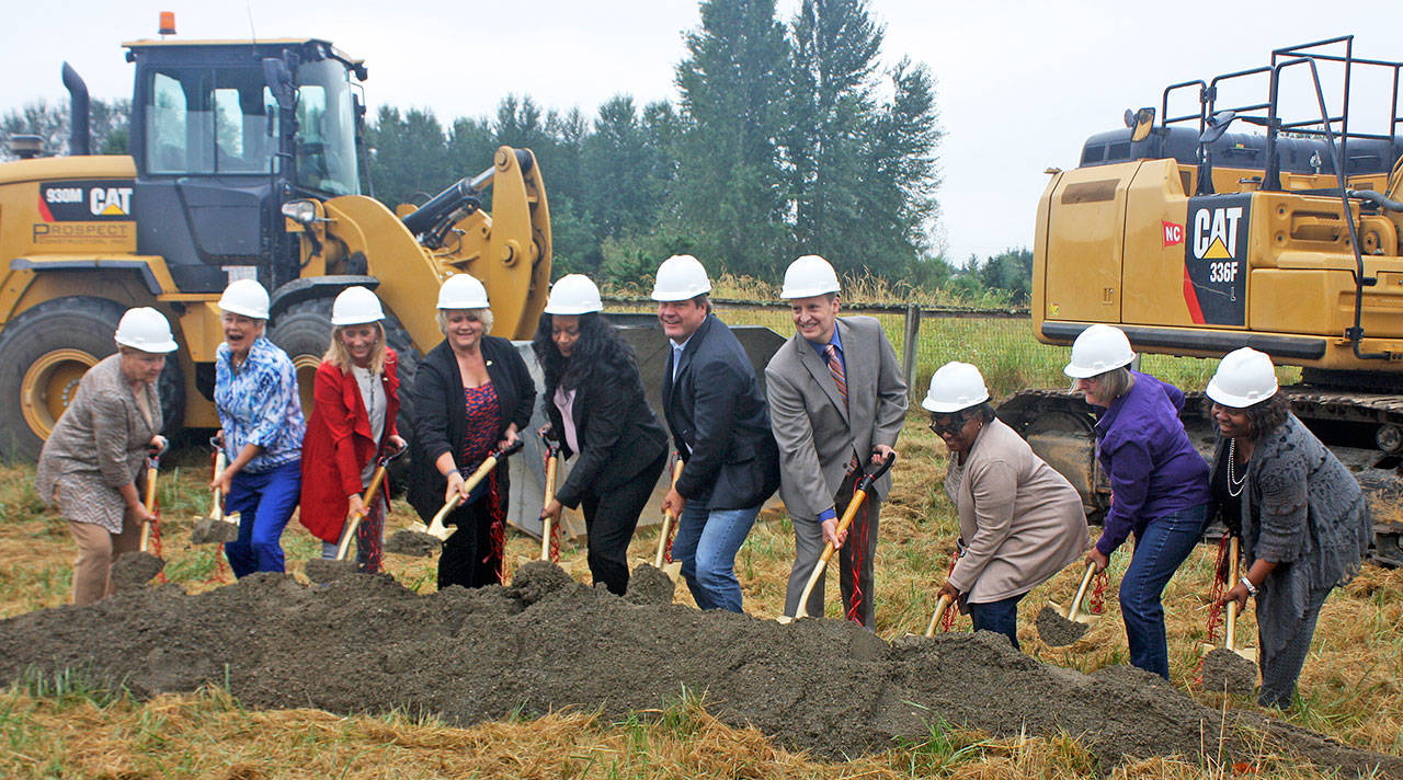 Local officials pick up shovels at the groundbreaking Thursday on the Lower Russell Setback Levee along the Green River in Kent. From left to right, State Sen. Karen Keiser, former Kent Mayor Suzette Cooke, Kent City Councilmember Toni Troutner, King County Flood District Control Executive Director Michelle Clark, King County Councilmember Reagan Dunn, King County Councilmember Dave Upthegrove, State Rep. Debra Entenman, Covington City Councilmember Marlla Mhoon and Kent City Councilmember Brenda Fincher. STEVE HUNTER, Kent Reporter