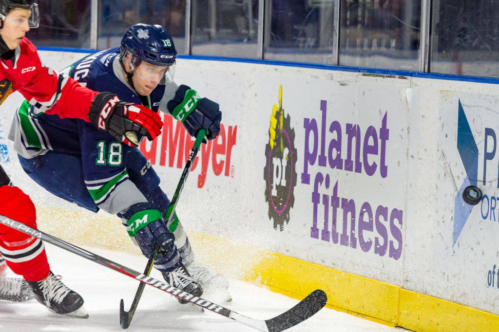 The Thunderbirds’ Andrej Kukuca chases the puck with a Winterhawk in pursuit during WHL play Saturday night. COURTESY PHOTO, Brian Liesse, T-Birds