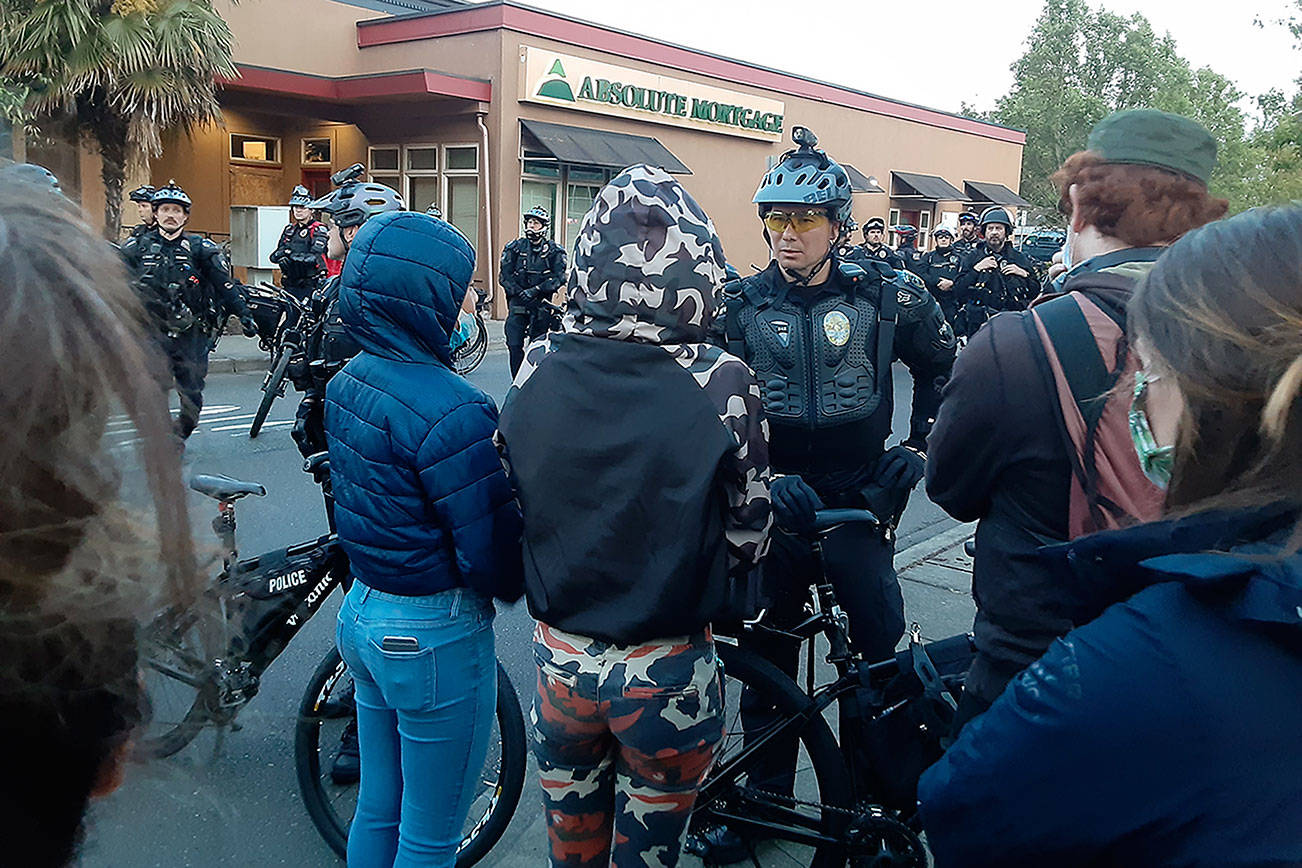 Robert Whale / Auburn Reporter                                Protesters confront Auburn police Tuesday evening in downtown Auburn.