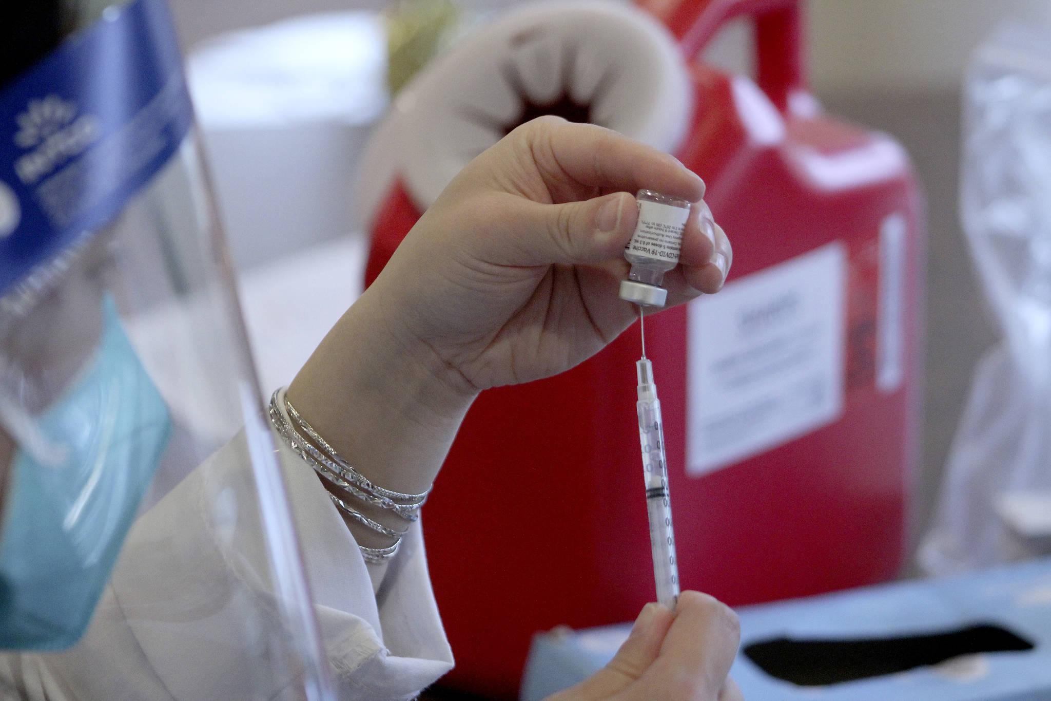 A CVS pharmacist prepares a shot of the Pfizer-BioNTech COVID-19 vaccine on Jan. 26 in Federal Way. Olivia Sullivan/the Mirror