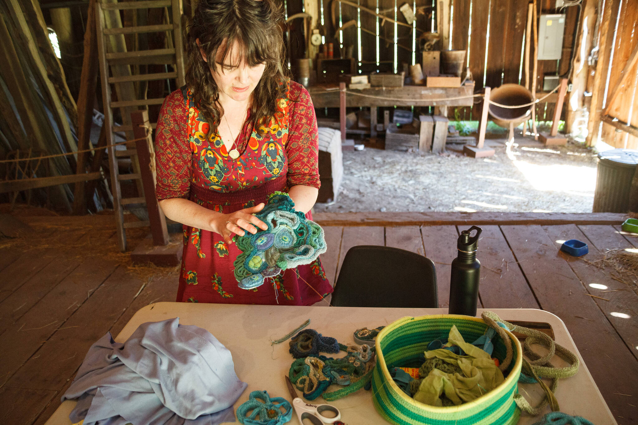 Amanda Triplett, Mary Olson Farm’s current Artist in Residence, explains the process of creating textile sculptures from scrap fabrics. Photo by Henry Stewart-Wood/Sound Publishing