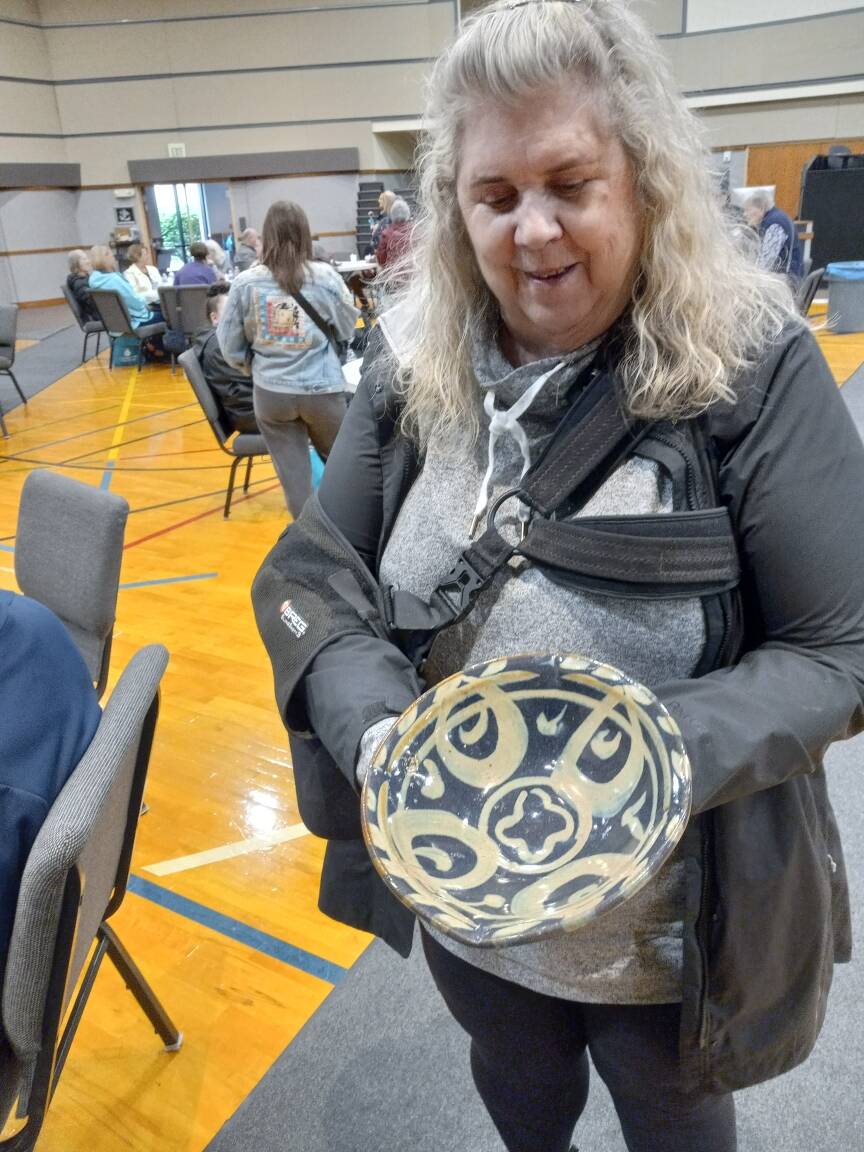 Nancy Peterson displays the bowl she took home from the Empty Bowls event April 26 at Grace Community Church in Auburn. Photo by Robert Whale/Auburn Reporter