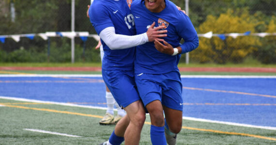 Davyd Fedina and Benji Toscano celebrate after taking the lead in the second half over Bainbridge. Ben Ray / The Reporter