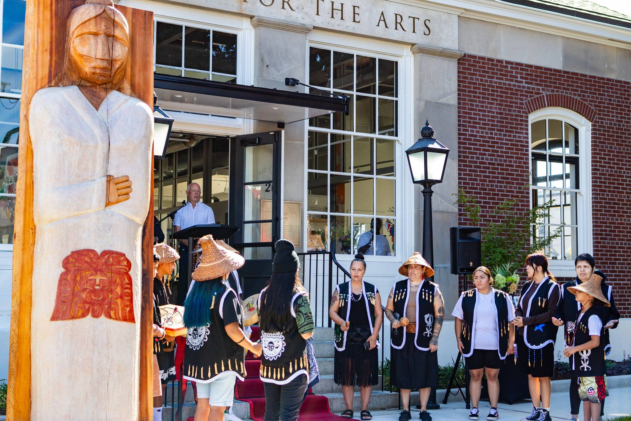 The Muckleshoot Indian Tribe unveil their gift of a Welcome Figure and provide a song and blessing during the Postmark Center for the Arts grand opening. File photo