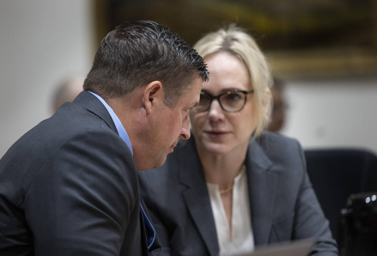 Jeffrey Nelson speaks with his counsel, Emma Scanlan. (Ken Lambert / The Seattle Times)