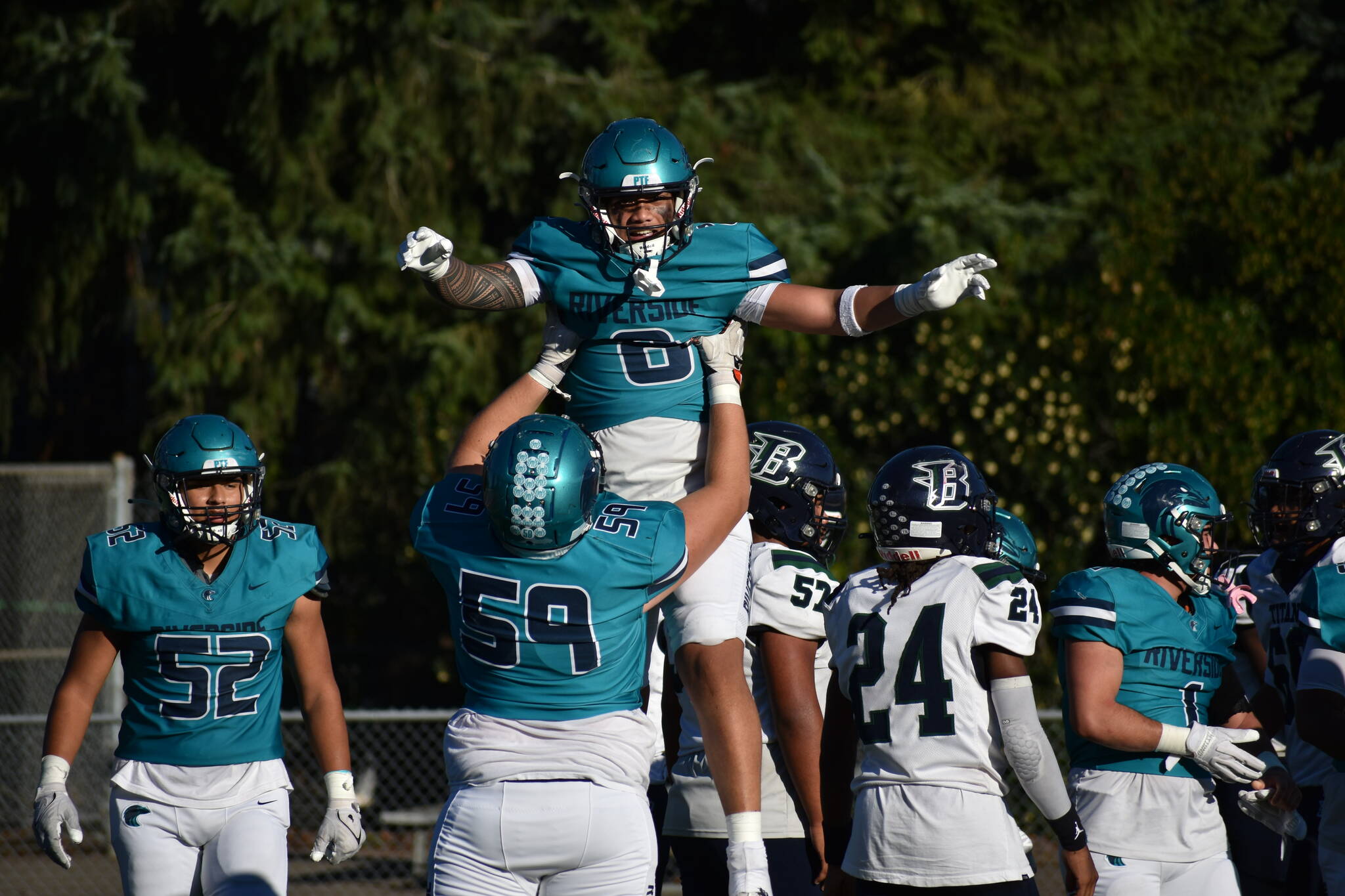 Auburn Riverside celebrates a touchdown. (Sound Publishing file photo)