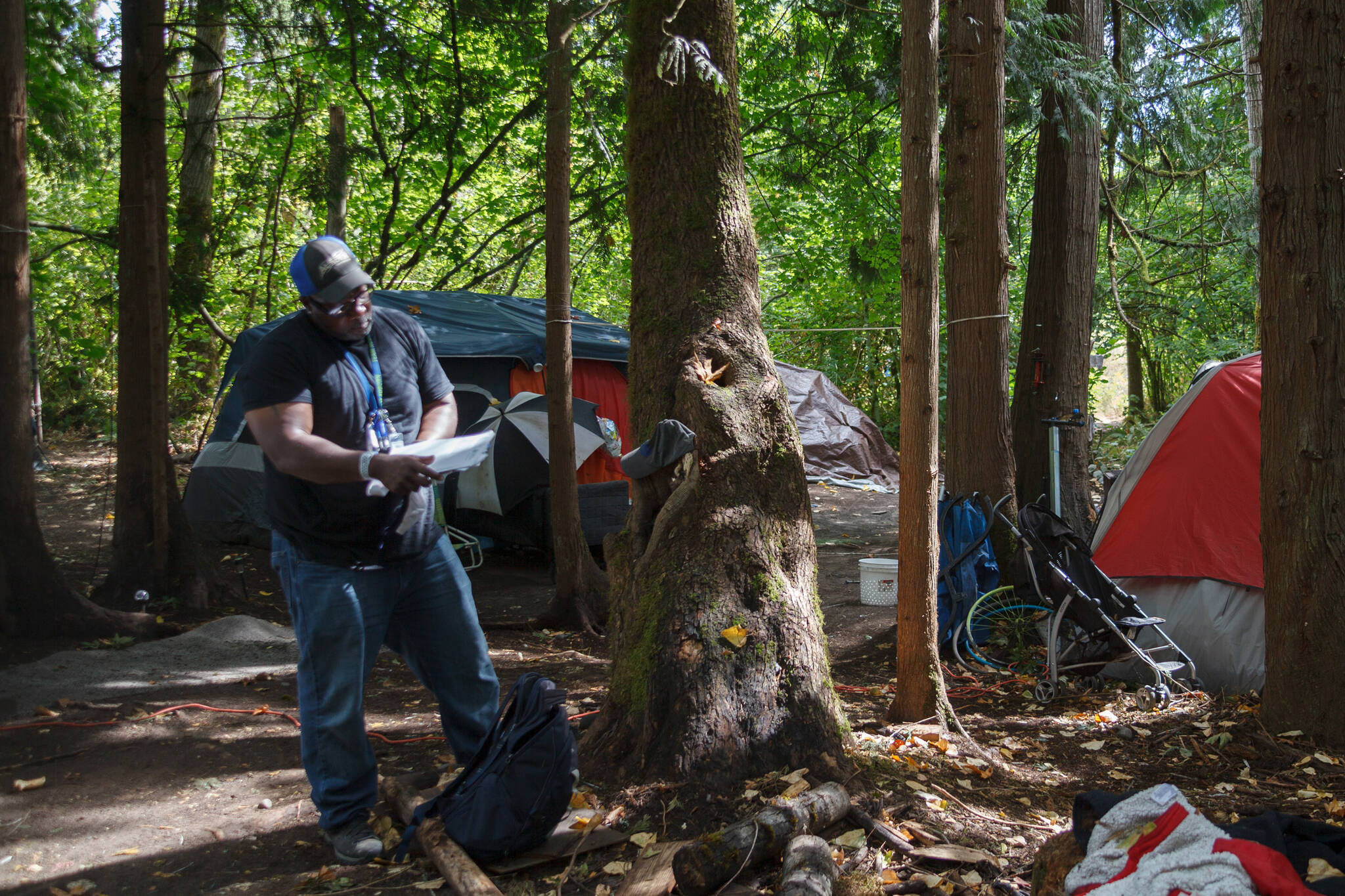 Homelessness Outreach Program Coordinator Kent Hay delivering mail to a resident of a homeless camp in Auburn. Sound Publishing file photo