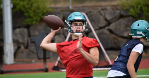 Quarterback Andrew Wold makes a throw during simulation drills act practice.