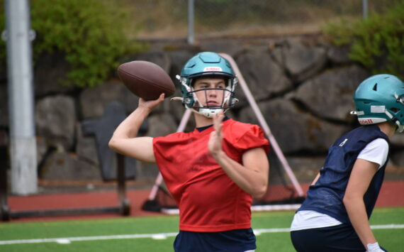 Quarterback Andrew Wold makes a throw during simulation drills act practice.