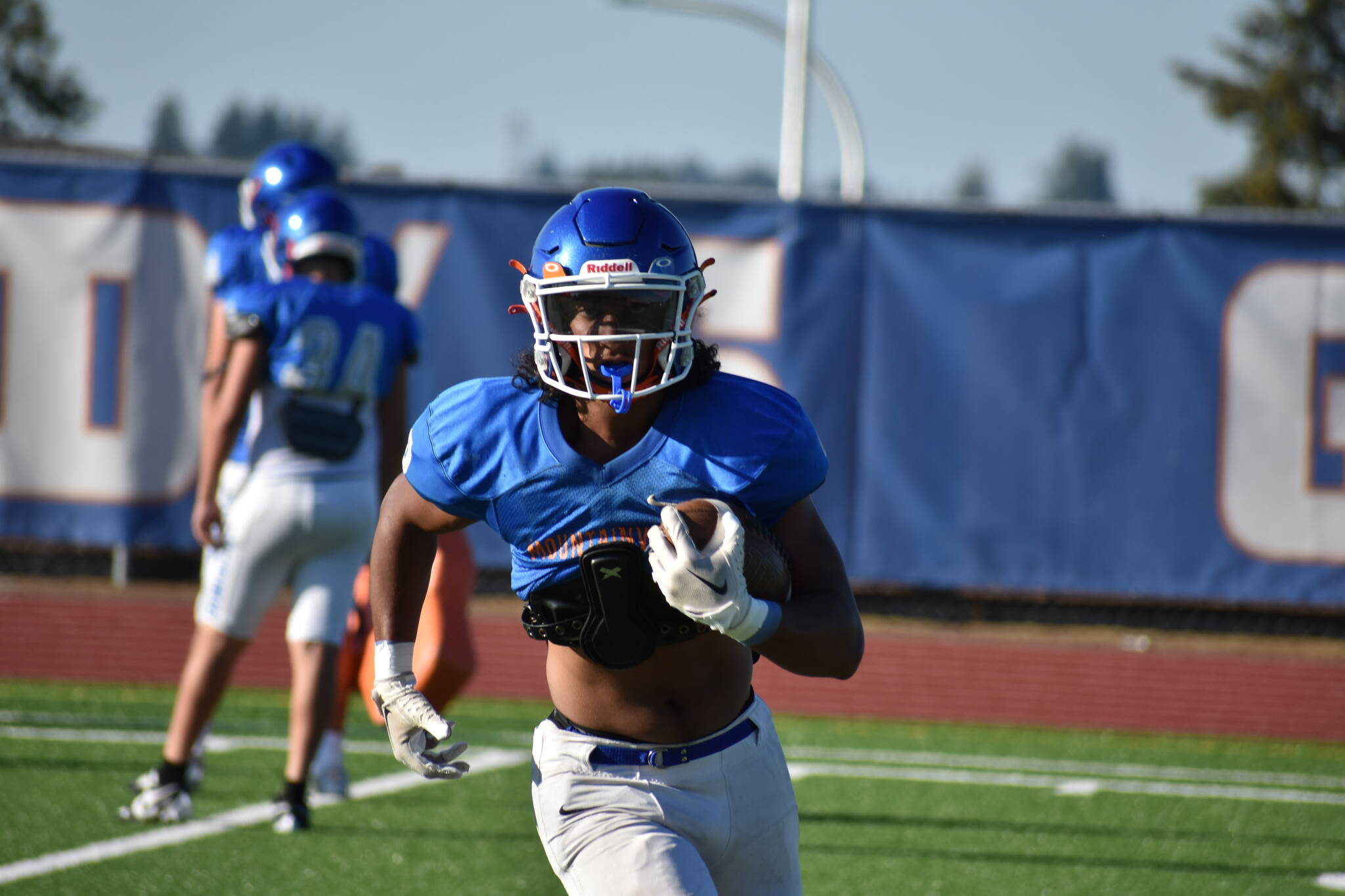 Senior Davion Munsen runs the ball after an interception. Ben Ray / The Reporter