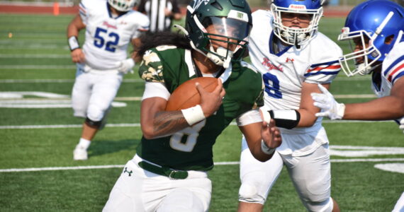 Auburn senior RJ Conlan shakes off a Kent-Meridian defender. Ben Ray / The Reporter