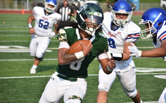 Auburn senior RJ Conlan shakes off a Kent-Meridian defender. Ben Ray / The Reporter