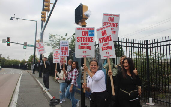 Workers stand outside of the Renton Boeing plant on the first day of the strike. Photo by Bailey Jo Josie/Sound Publishing.