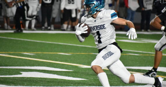 Raven junior Isaac Mospanko runs upfield for Auburn Riverside. Ben Ray / The Reporter