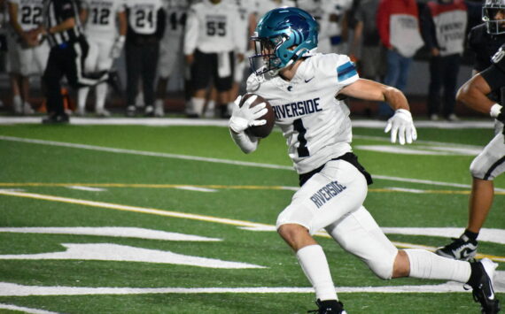 Raven junior Isaac Mospanko runs upfield for Auburn Riverside. Ben Ray / The Reporter