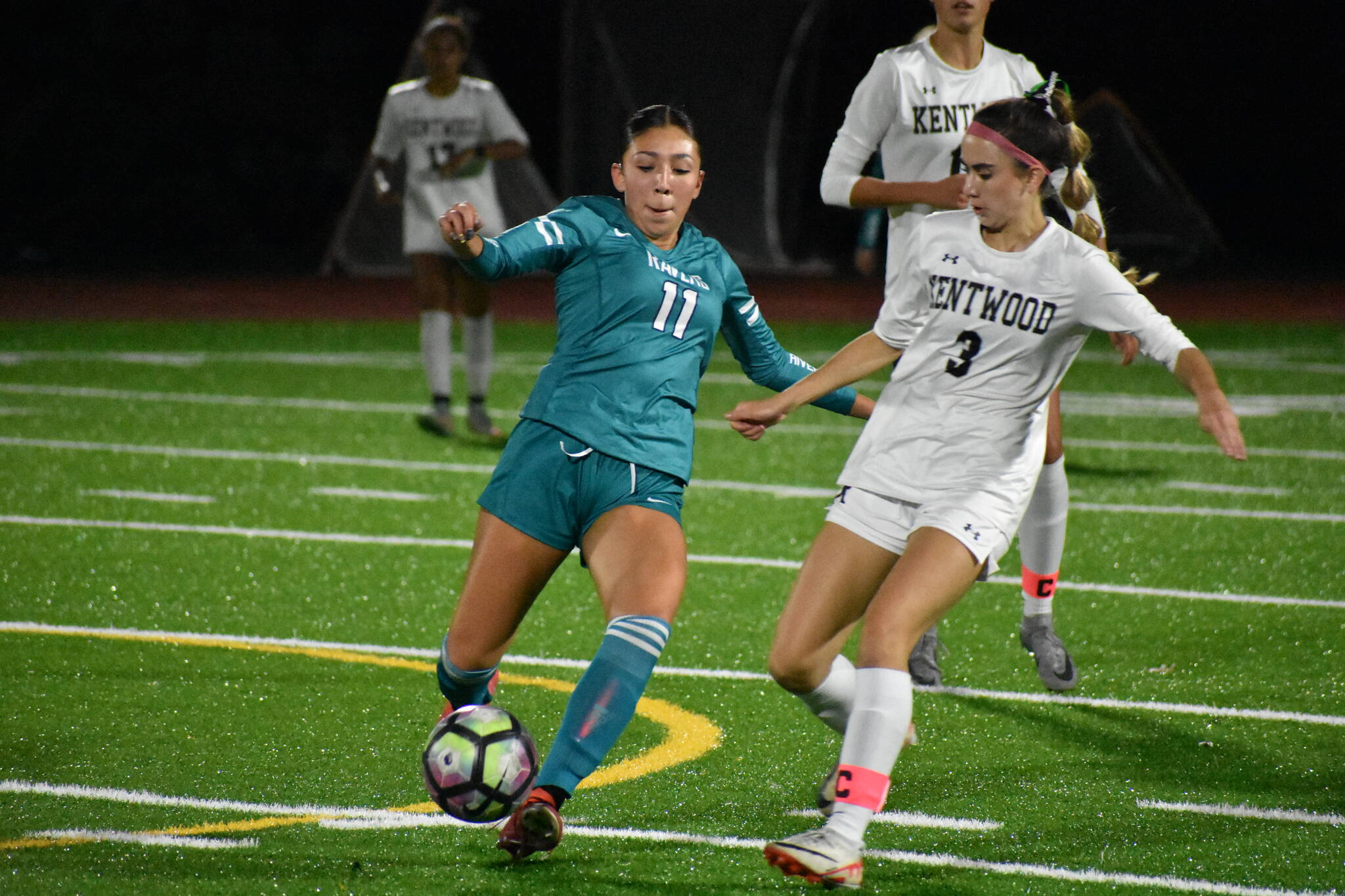 Raven sophomore Alexis Novoa takes on a Kentwood player. Ben Ray / The Reporter