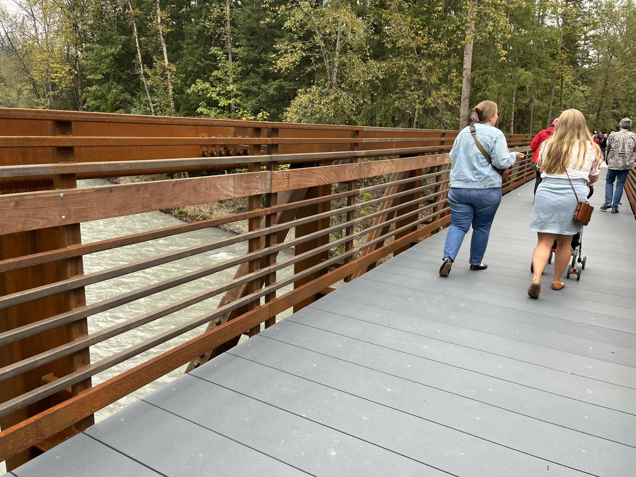 Above, pedestrians try out the new bridge Oct. 1 at Game Farm Park.