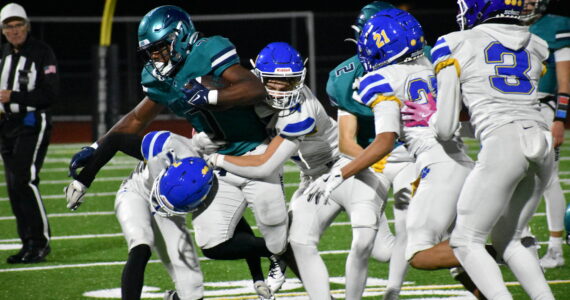 Jonathan Epperson takes on a slew of Tiger tacklers in the second half. Ben Ray / The Reporter