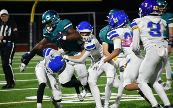 Jonathan Epperson takes on a slew of Tiger tacklers in the second half. Ben Ray / The Reporter