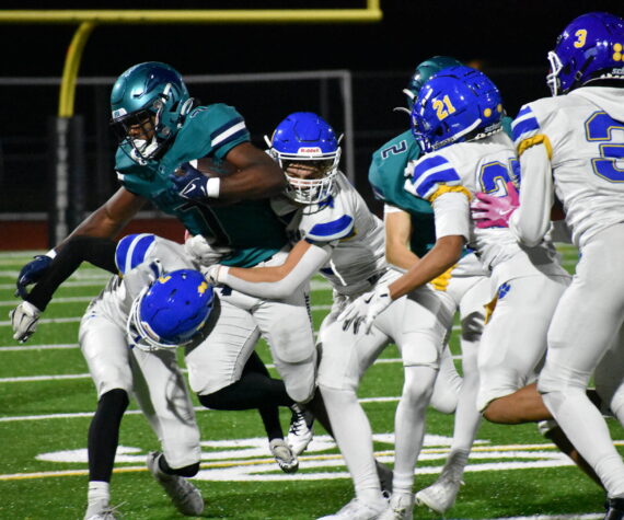 Jonathan Epperson takes on a slew of Tiger tacklers in the second half. Ben Ray / The Reporter