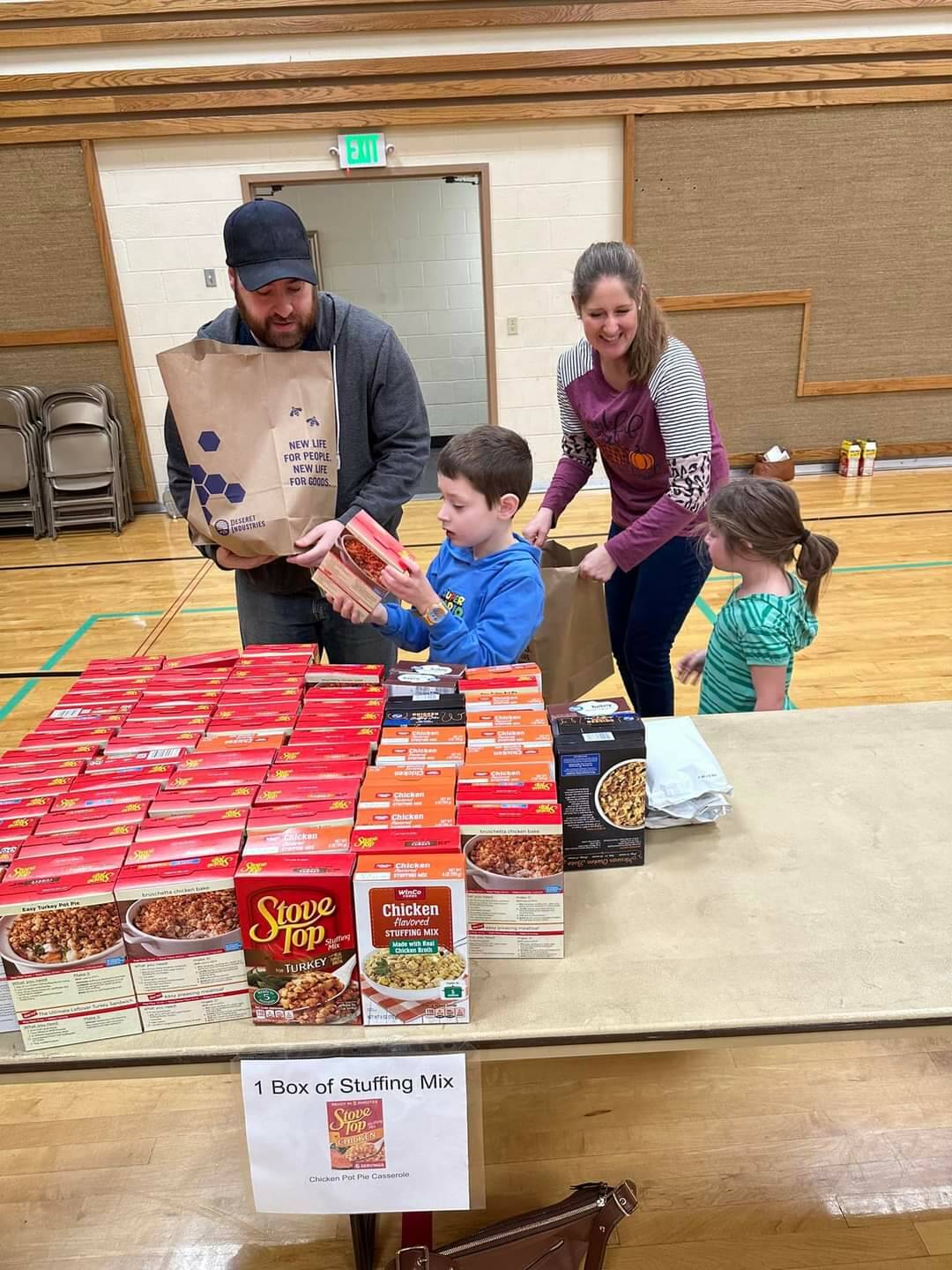 Seth and Katie Price, along with their children Isaac and Brielle, assemble meals-in-a-bag at the Auburn congregation of The Church of Jesus Christ of Latter-day Saints for families in need, as part of a food drive benefiting Vine Maple Place. Courtesy photo