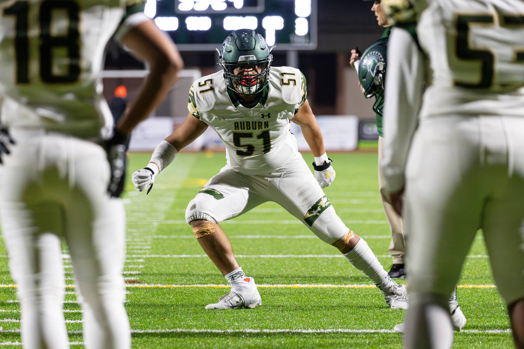 Mac Johns #51 of the Auburn Trojans warms up before a football game against the Sumner Spartans at Sunset Chev Stadium on Nov. 8. Photos by Henry Rodenburg