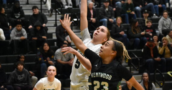 Trojan sophomore Morgan Richardson gets in a lay-up against Kentwood. Ben Ray / The Reporter