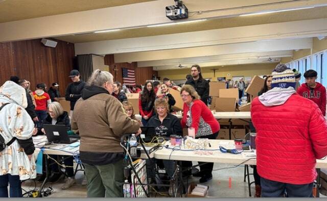 Auburn Food Bank Director Debbie Christian and Auburn Mayor Nancy Backus at the Dec. 23 annual Christmas distribution of food boxes for local people and families in need in the Fellowship Hall at Holy Family Catholic Church. Courtesy photo, City of Auburn