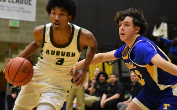 Trojan junior Daniel Johnson drives to the basket. Ben Ray / The Reporter