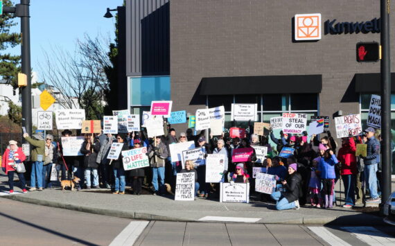 Fifty protesters held up a variety of signs at the Renton location for the Jan. 18, 2024 Women’s March and People’s March. Photo by Bailey Jo Josie/Sound Publishing.