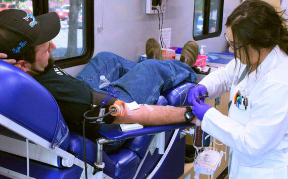 A mobile center from Bloodworks Northwest takes blood from Enumclaw resident Andy Bremmeyer, pictured in this 2019 photo. Sound Publishing file photo